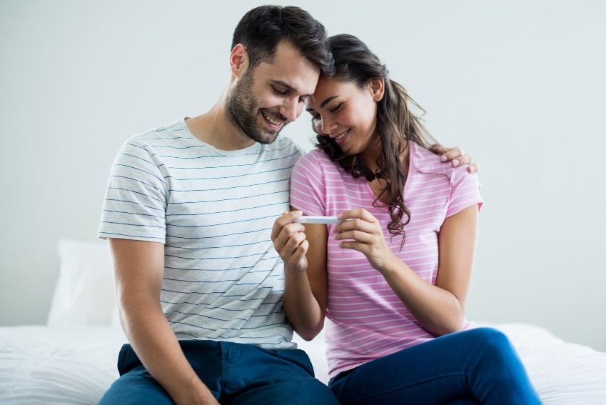 joyful-couple-finding-out-results-pregnancy-test-bedroom-home (1)